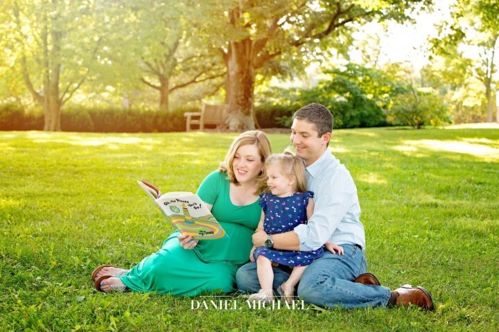 Parents reading book to child